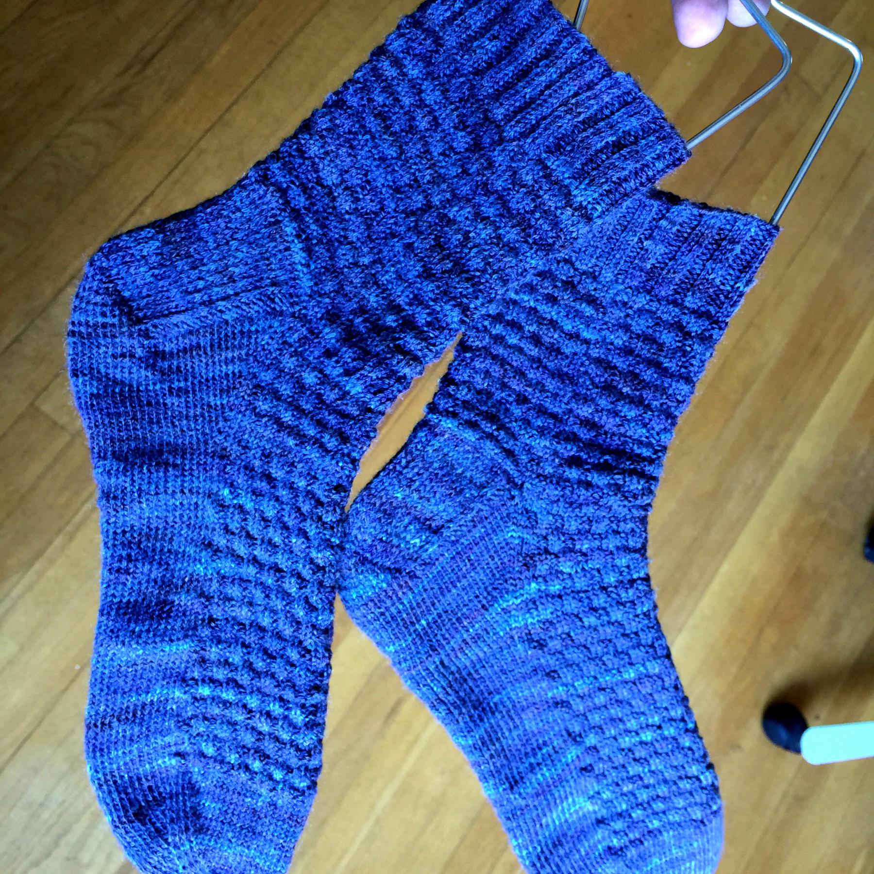 finished socks on sock hangers