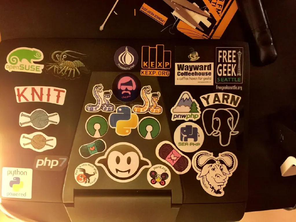 Laptop with stickers for yarn, Perl, and assorted FOSS topics