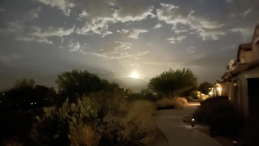 Clouds and hazy sky lit up by very bright moon