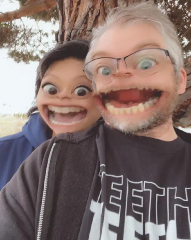Snapchat filter exaggerating a couple’s smiling faces