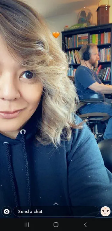 Snapchat selfie of @IamMrsGeek with me working in the background