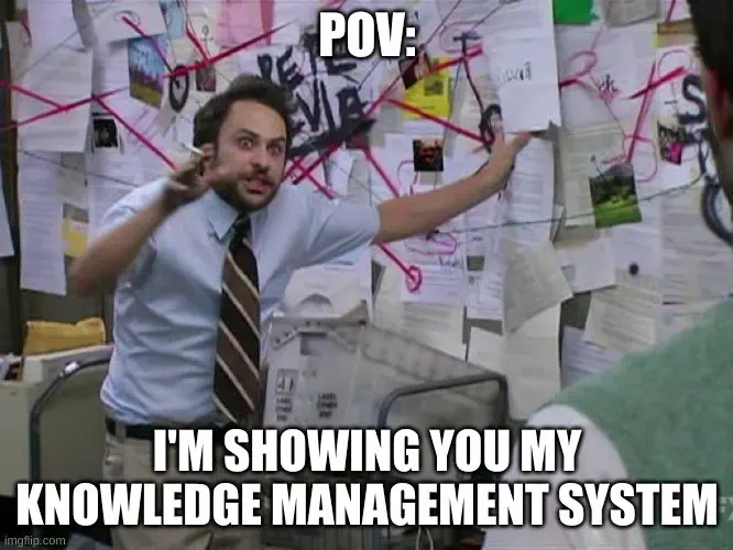 Always Sunny Charlie conspiracy theory meme, with manic-looking dude waving a cigarette and pointing at a clutter of connected notes; caption reads &ldquo;POV: I&rsquo;m showing you my knowledge management system&rdquo;