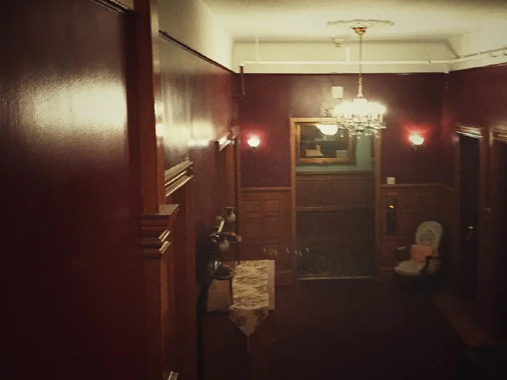 Open elevator in red Victorian hallway