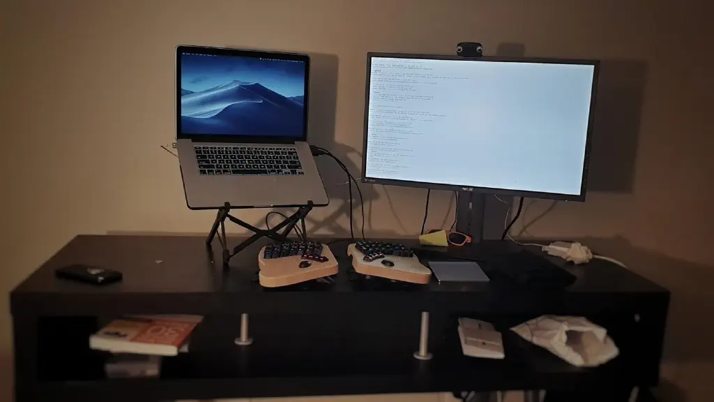 standing desk with laptop and monitor setup