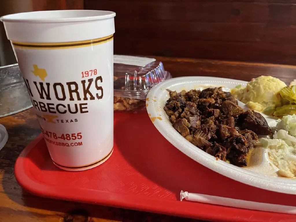 Chopped beef plate with sweet tea and a slice of pecan pie, from iron works barbecue in Austin TX