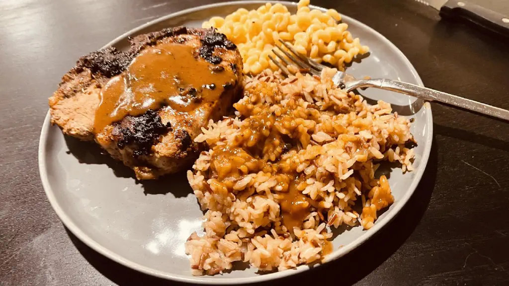 Pork chops, wild rice, cheese noodles, and brown gravy 