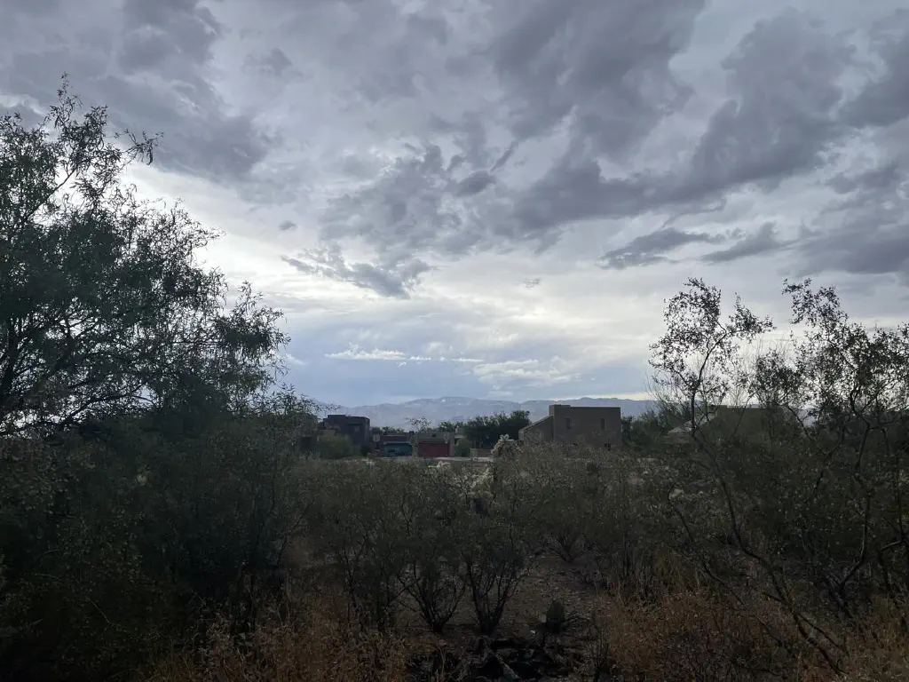 Dramatic clouds layered over mountain skyline