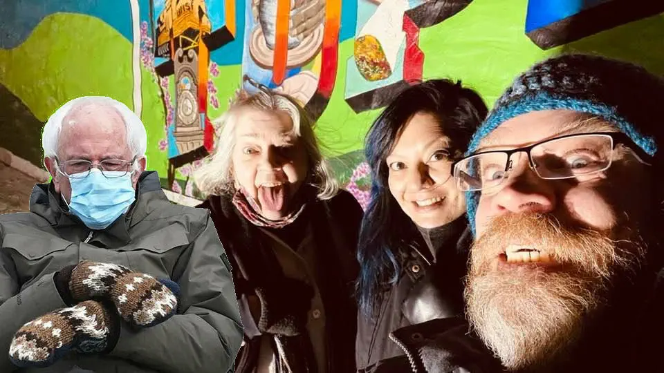 Three people being goofy for the camera, with sitting Bernie Sanders image photoshopped in