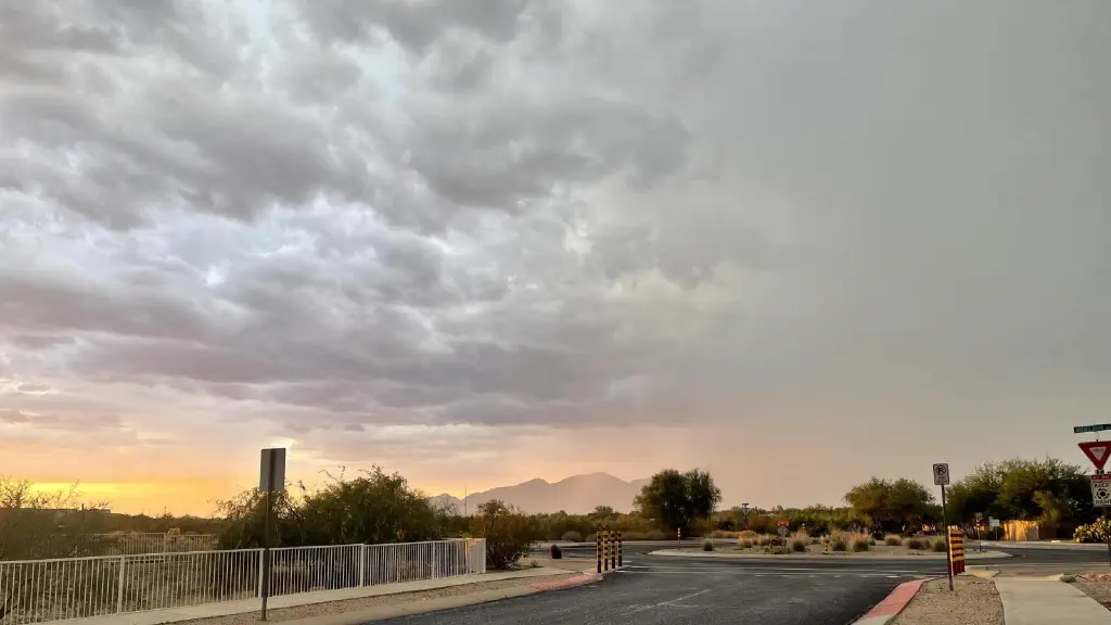 Sunset with heavy clouds, mountains obscured by rain mist lit res by the sunset 