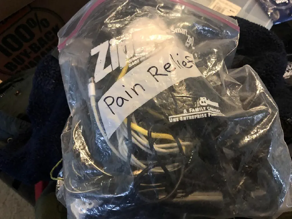Ziploc bag full of electronic cables, with “pain relief” written in sharpie