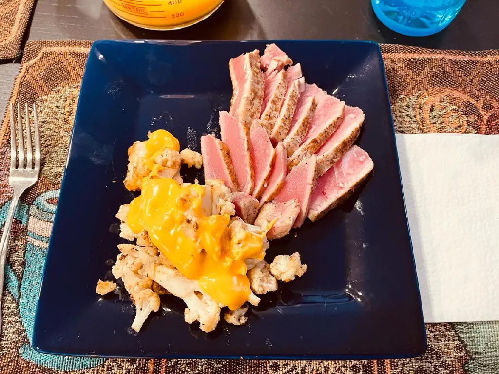 Seared tuna and roasted cauliflower, with cheese sauce on the cauliflower