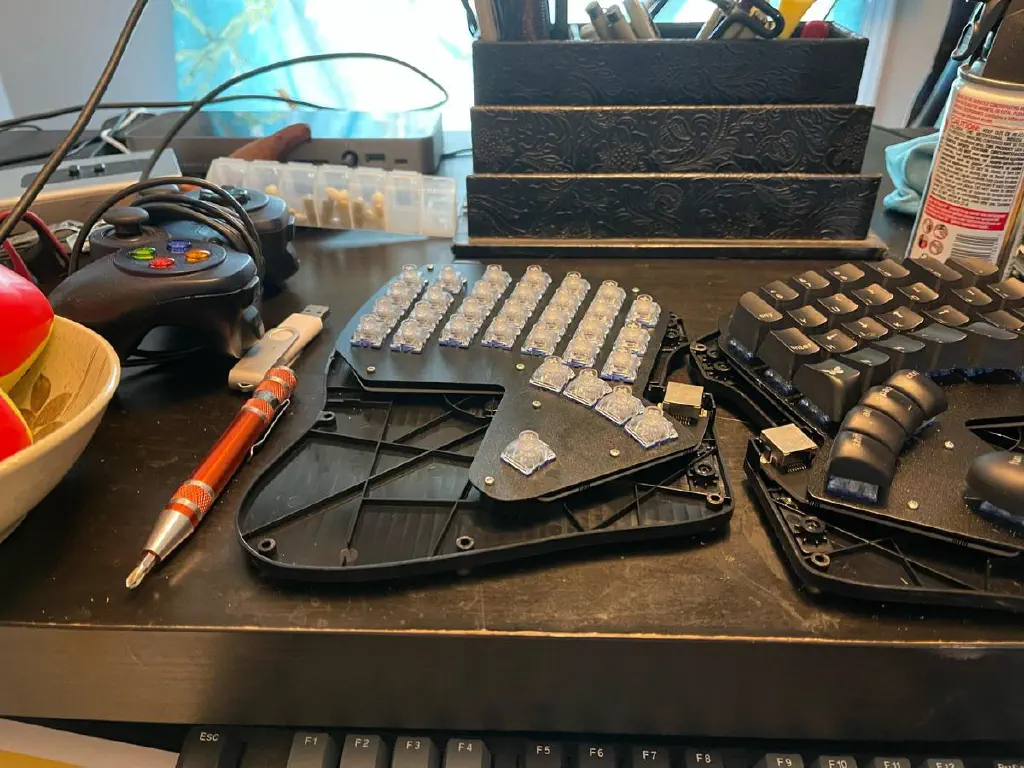 Split ergonomic keyboard with cover off and keycaps removed from left section
