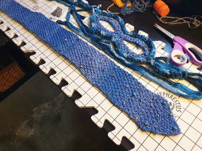 knitted tie and matching crochet mask, with rhinestone rivets laid out