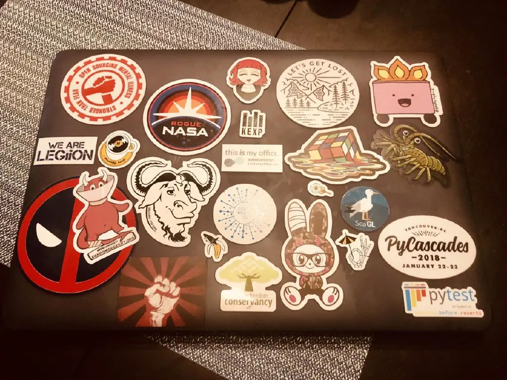 Laptop with stickers on case. 