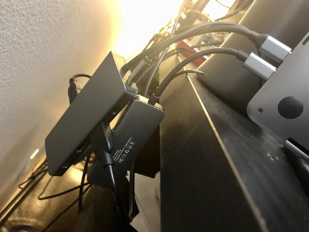 Multiple portable USB-C hubs plugged into a MacBook Pro 