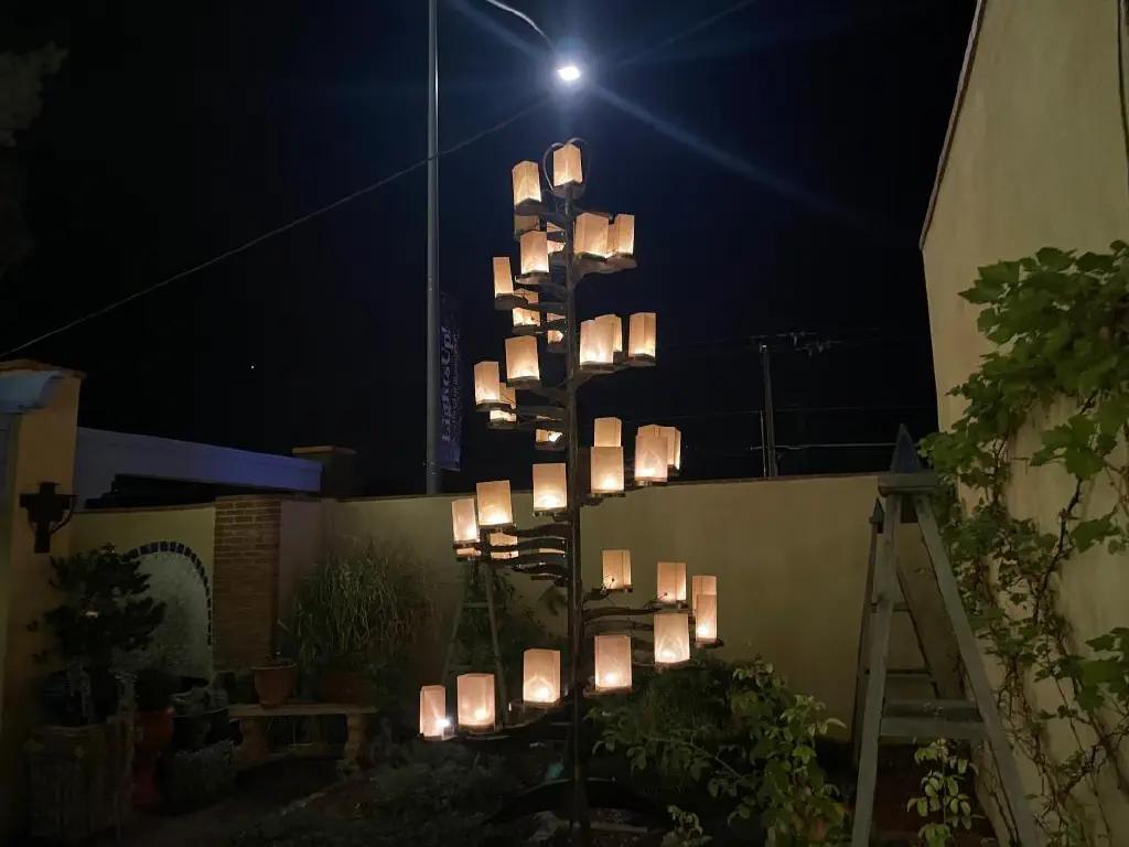 Tree-shaped sculpture with a rising spiral of paper lanterns forming its body