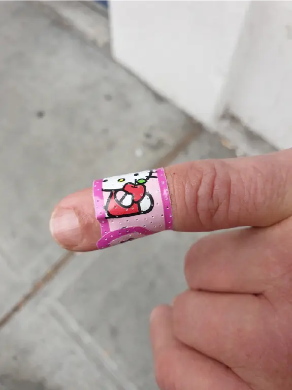 &ldquo;Hello Kitty&rdquo; band-aid applied to a pinky