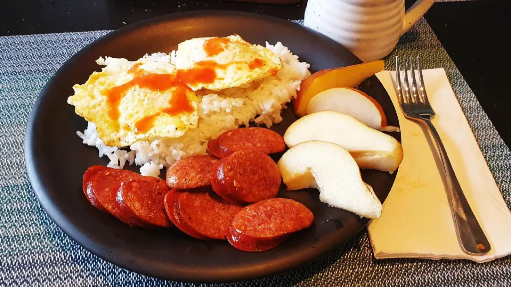 Eggs over rice with sausage and pears