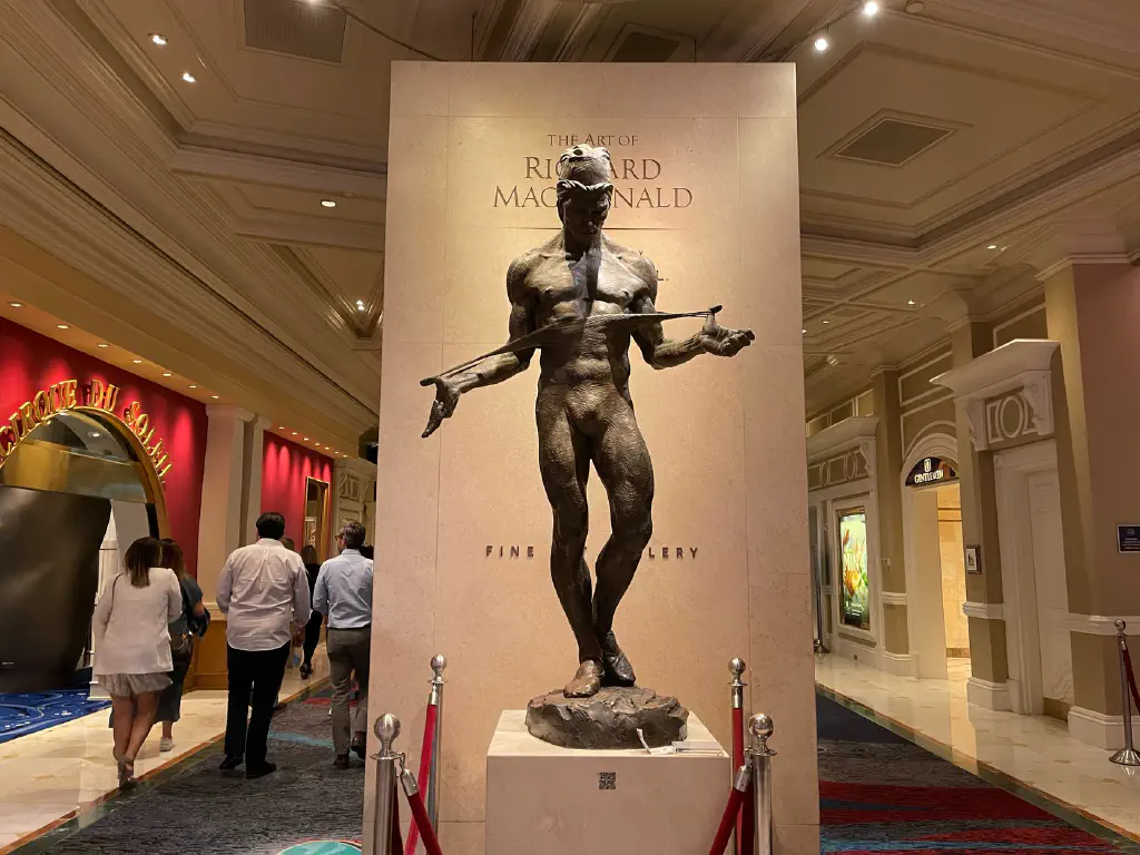 Bronze statue of dancer, in high contrasting overhead light