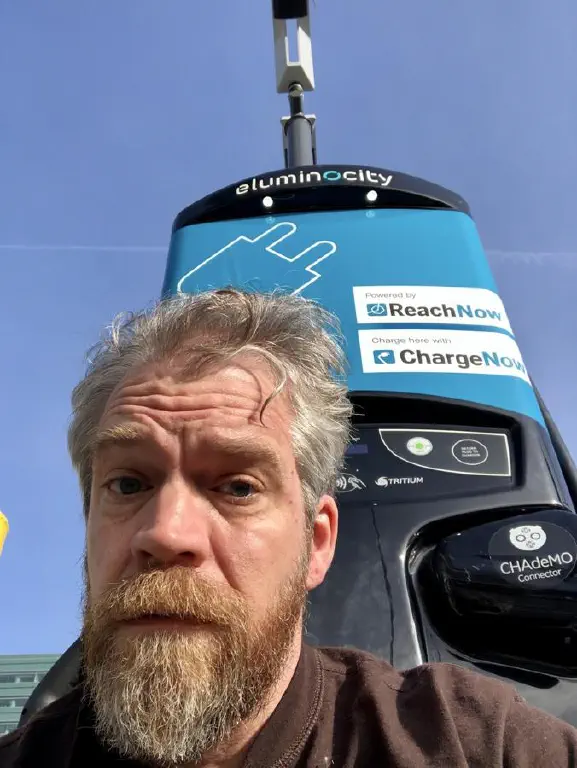 Selfie in front of charging station for electric cars