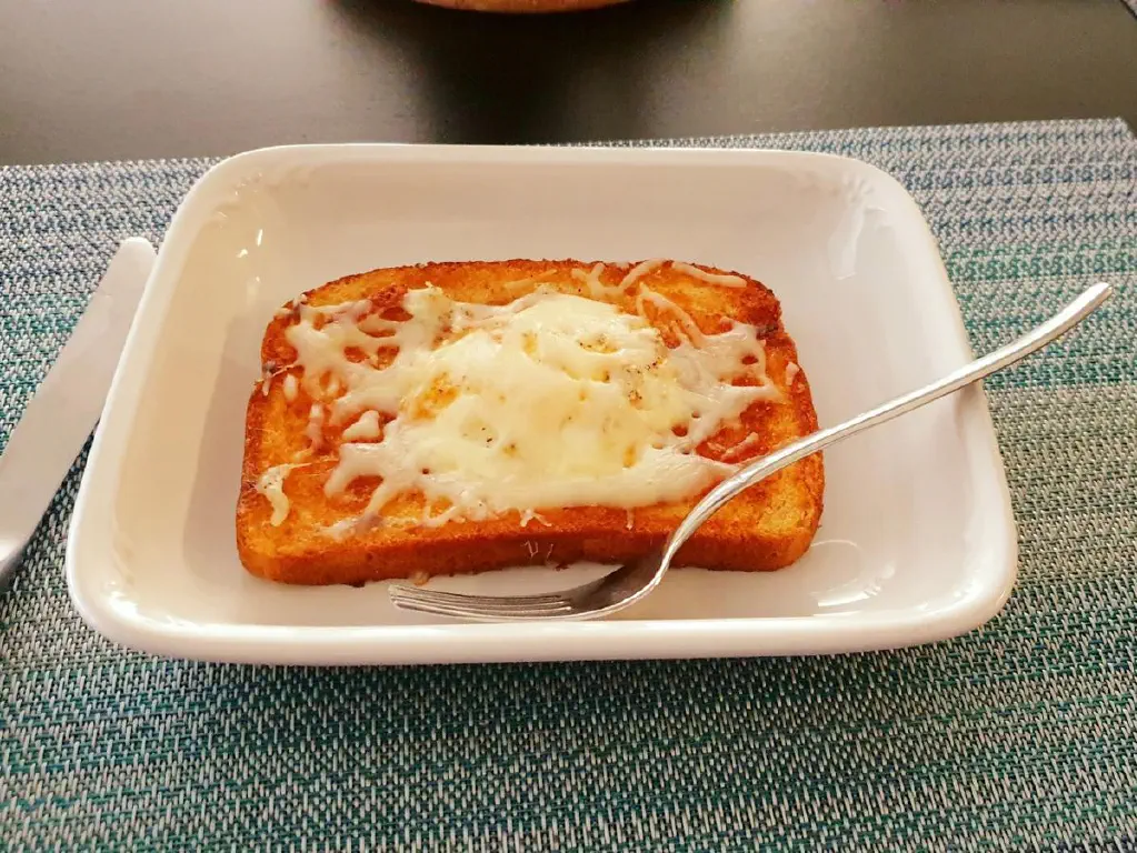 Eggs in toast, covered with cheese