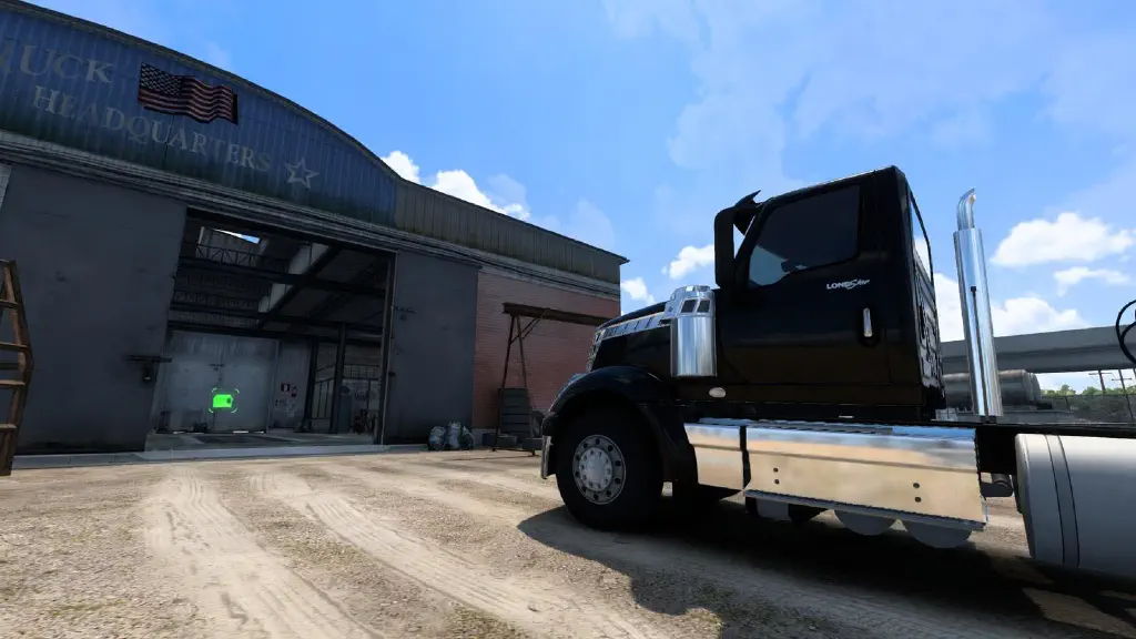 American Truck Simulator screenshot with a black semi truck parked in front of a very shoddy garage