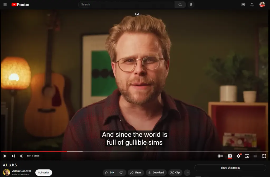 freeze frame of linked video with closed caption text reading &ldquo;And since the world is full of gullible sims&rdquo;