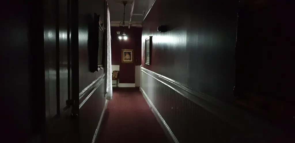 Dark hallway lit by emergency lights
