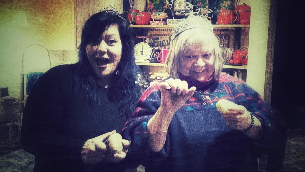 Two women making silly expressions while holding potatoes and peelers