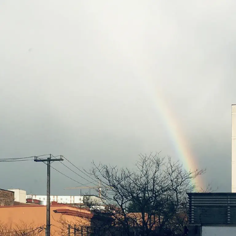 Fading rainbow over buildings 