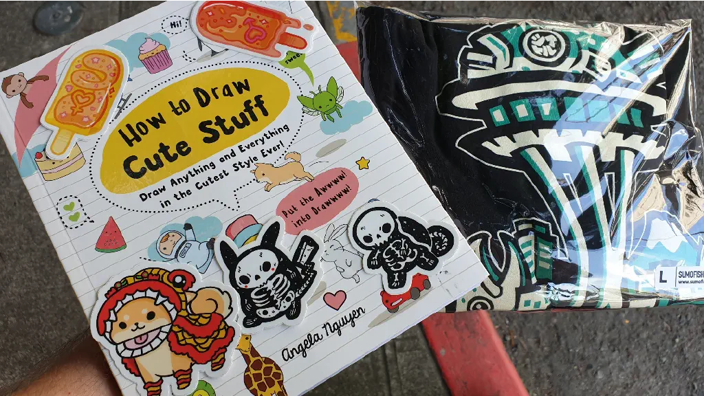 &ldquo;How To Draw Cute Stuff&rdquo; book and stickers by Angela Nguyen; stylized Seattle t-shirt by Sumofish