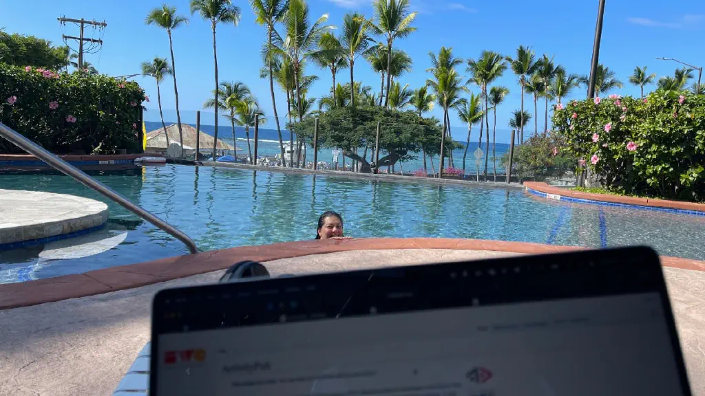 sitting by the pool near the beach while she&rsquo;s in the pool