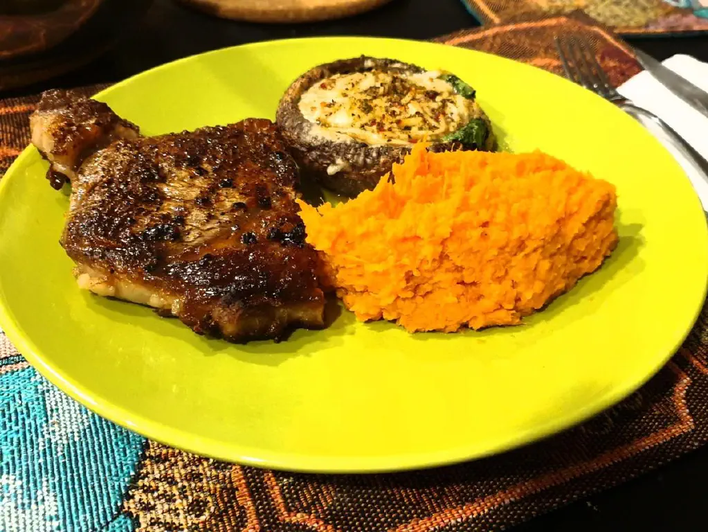 Steak, stuffed portobello mushrooms, and mashed sweet potatoes