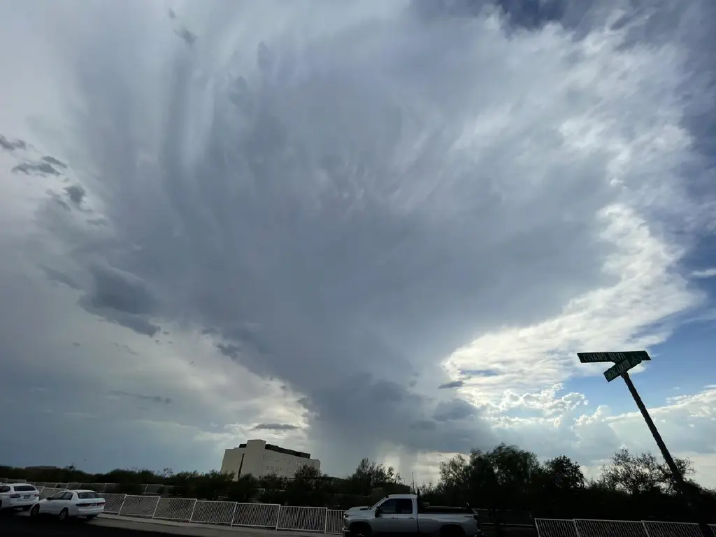 view from underneath a large nearby thundercloud