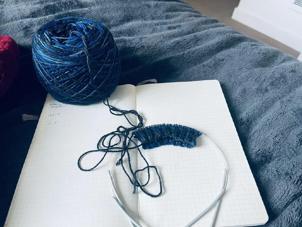 Freshly started knitting in variegated blue tones