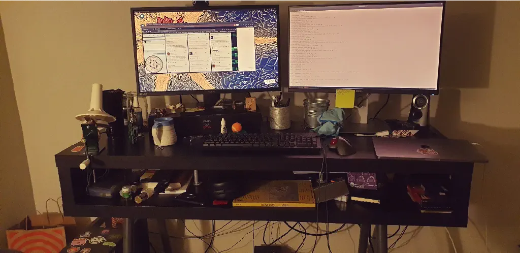 IKEA hack standing desktop with two monitors and lots of junk