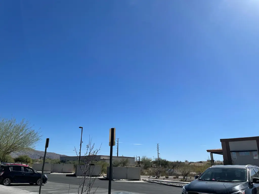 Clear blue sky over a desert parking lot