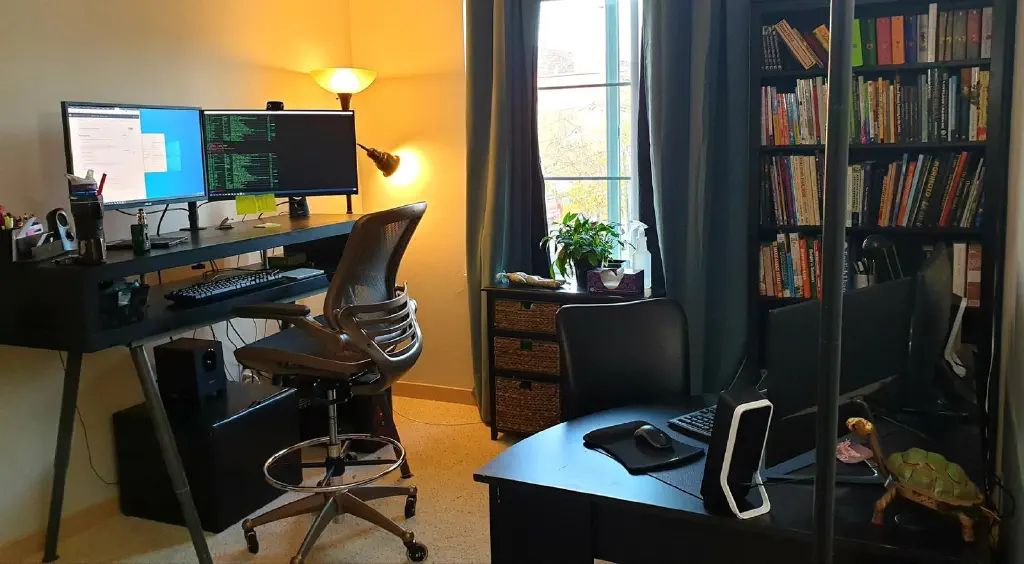 Home office with two desks, each facing a wall