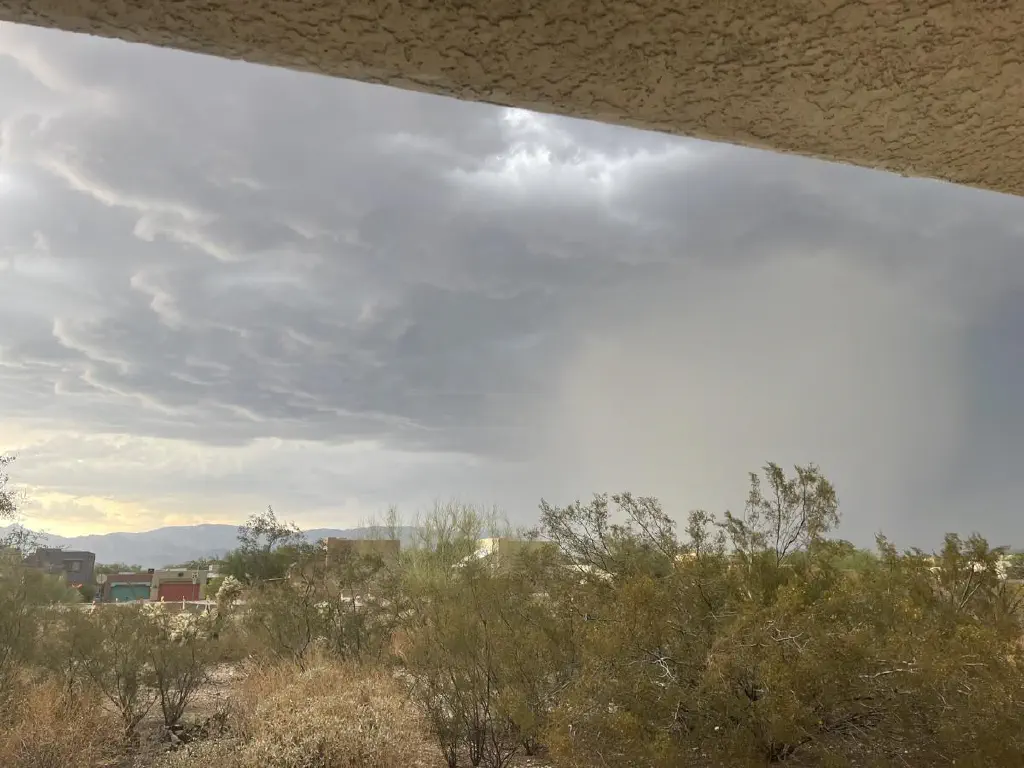Bottom of dark clouds obscured by a growing fog of dust and rain