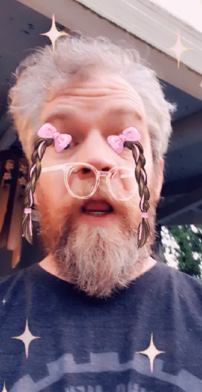 Snapchat selfie with cartoon pigtails coming out of my eyes and glasses in front of my nostrils