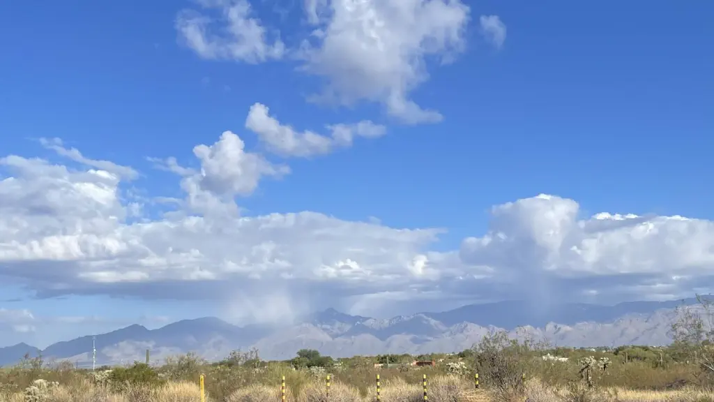 Clouds visibly dumping precipitation on the Santa Catalina mountains