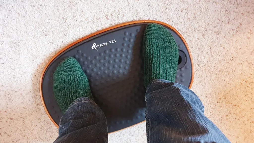 Feet in green socks on Strongtek balance board