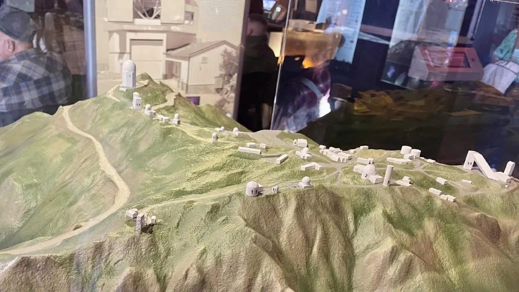 A small replica model of the Kitt Peak Observatory buildings, lid out on replica mountain peaks
