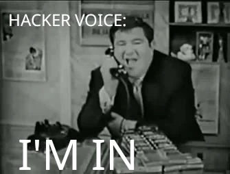 Buddy Hackett on the phone; top caption reads “HACKER VOICE:”; bottom caption in larger text reads “I’M IN”