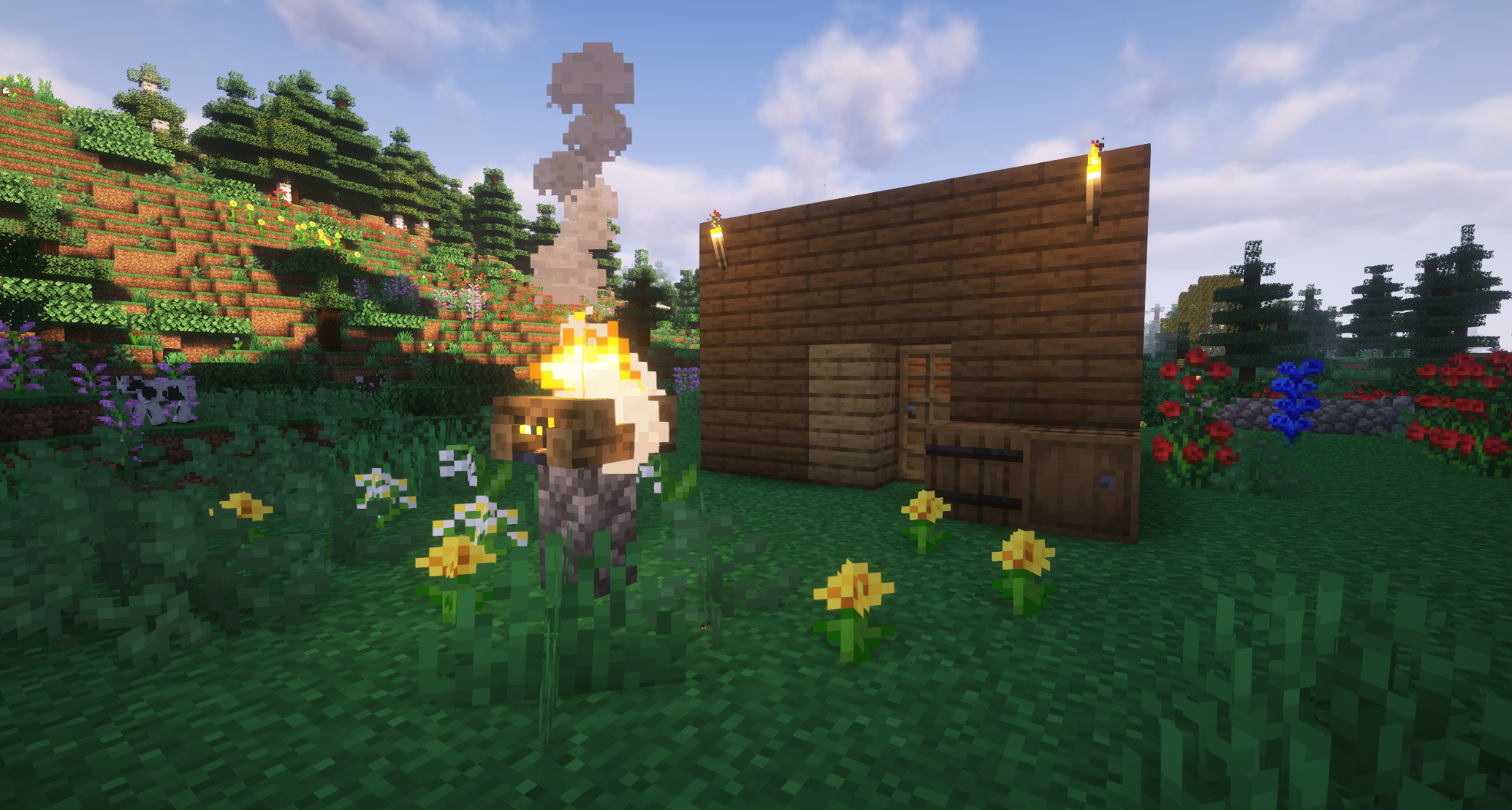 small rectangular wooden panel house in a valley full of flowers and trees, lit by torches and a campfire mounted on cobblestone fencepost
