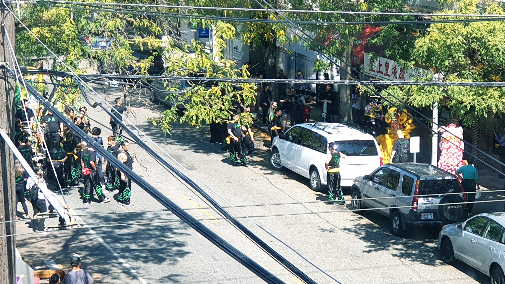 People on street including some in Chinese dragon costumes