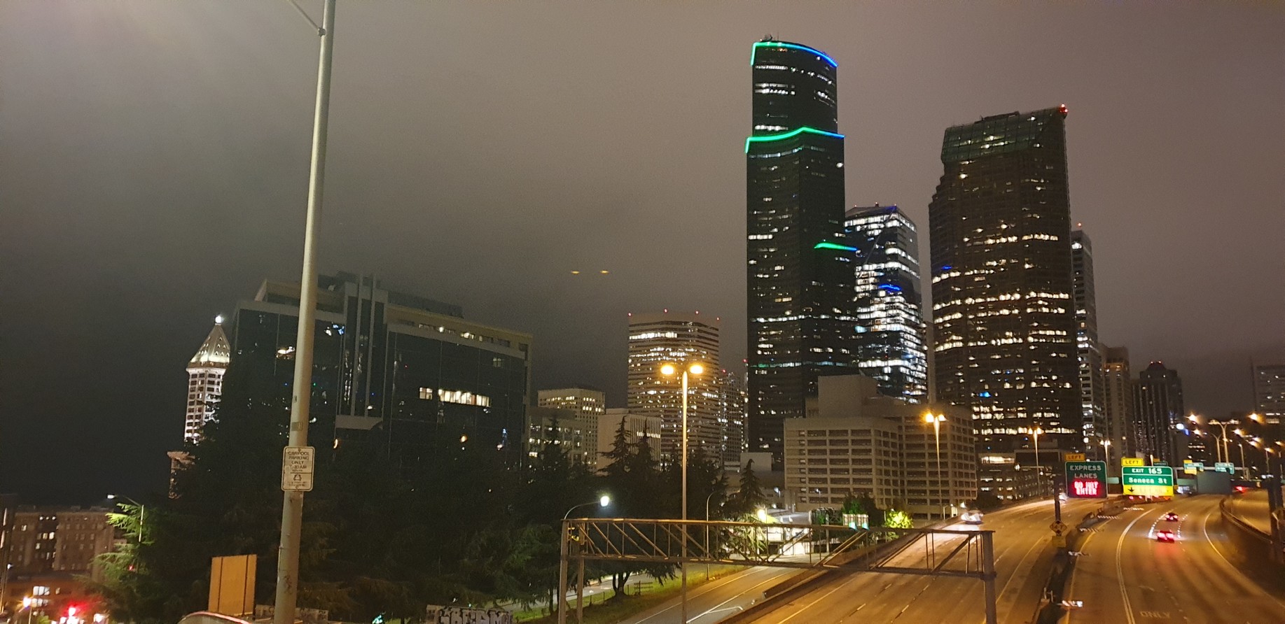 Nighttime Seattle skyline with clouds lit by city