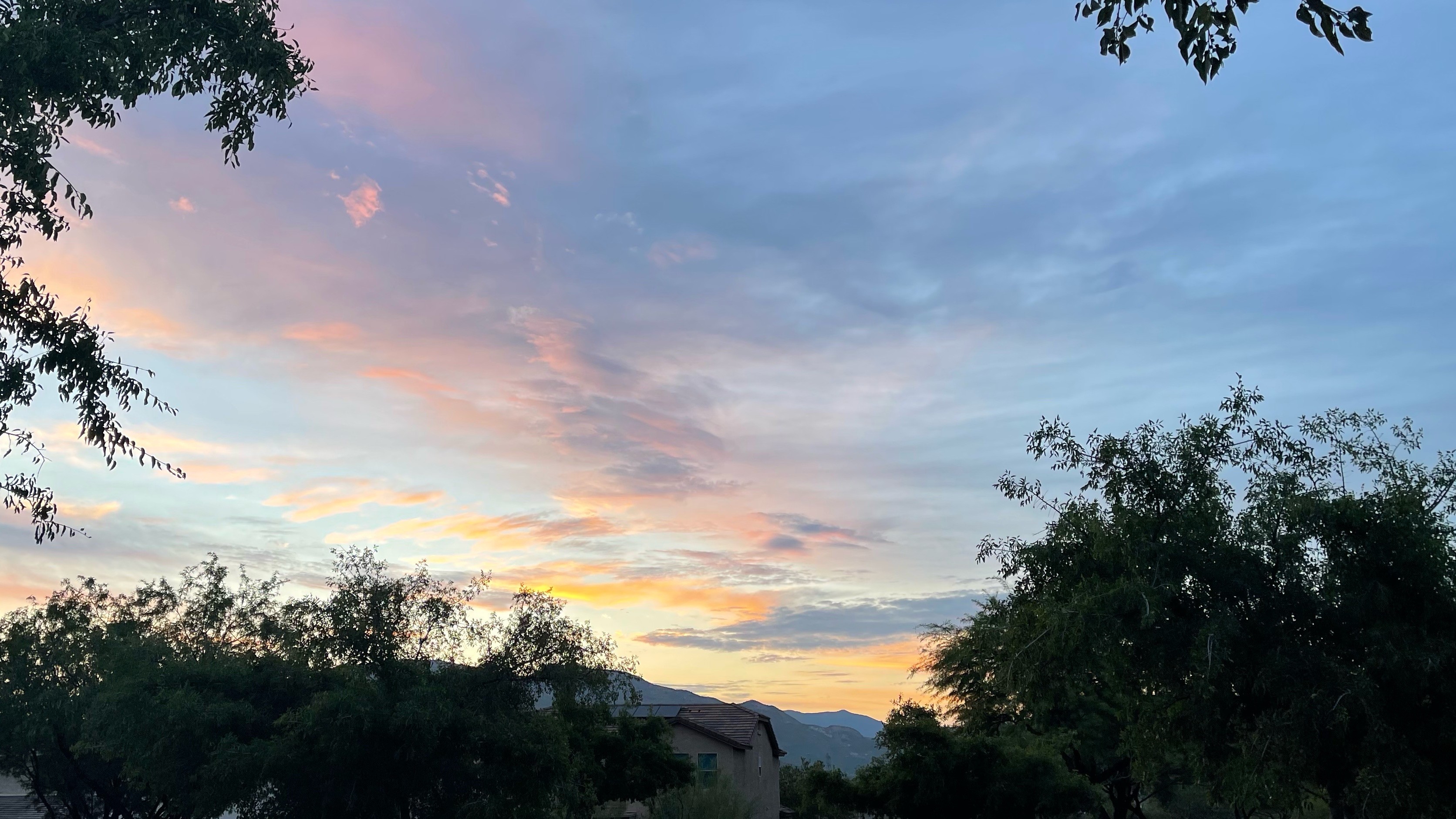 Clouds lit up orange by pre-dawn sun