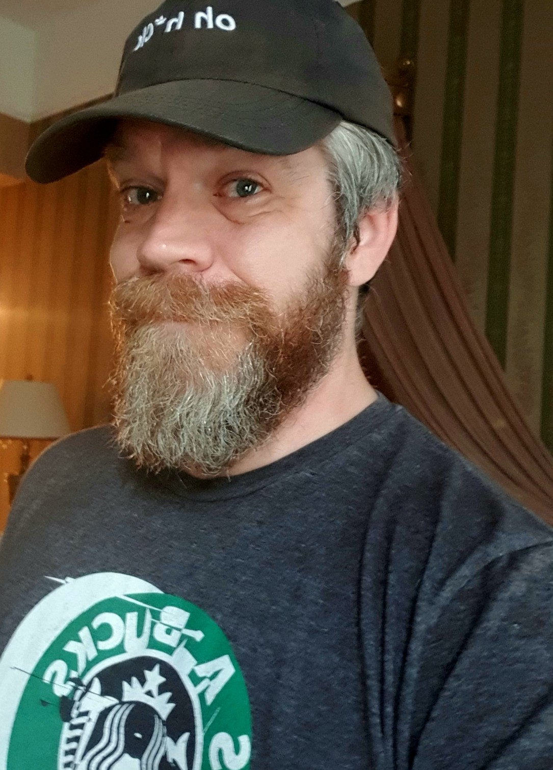 Selfie wearing dog rates “oh h*ck” cap and glitch logo “starbucks” t shirt